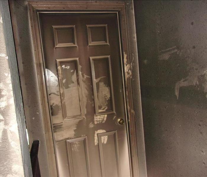 white door covered with smoke and soot